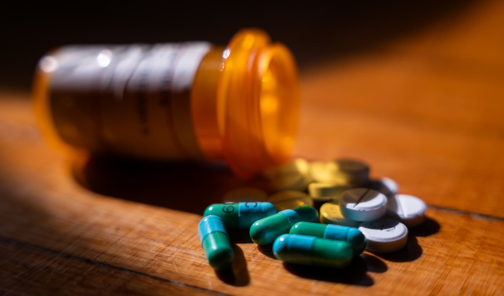 In a photo illustration, prescription drugs are seen next to a pill bottle on July 23, 2024 in New York City.