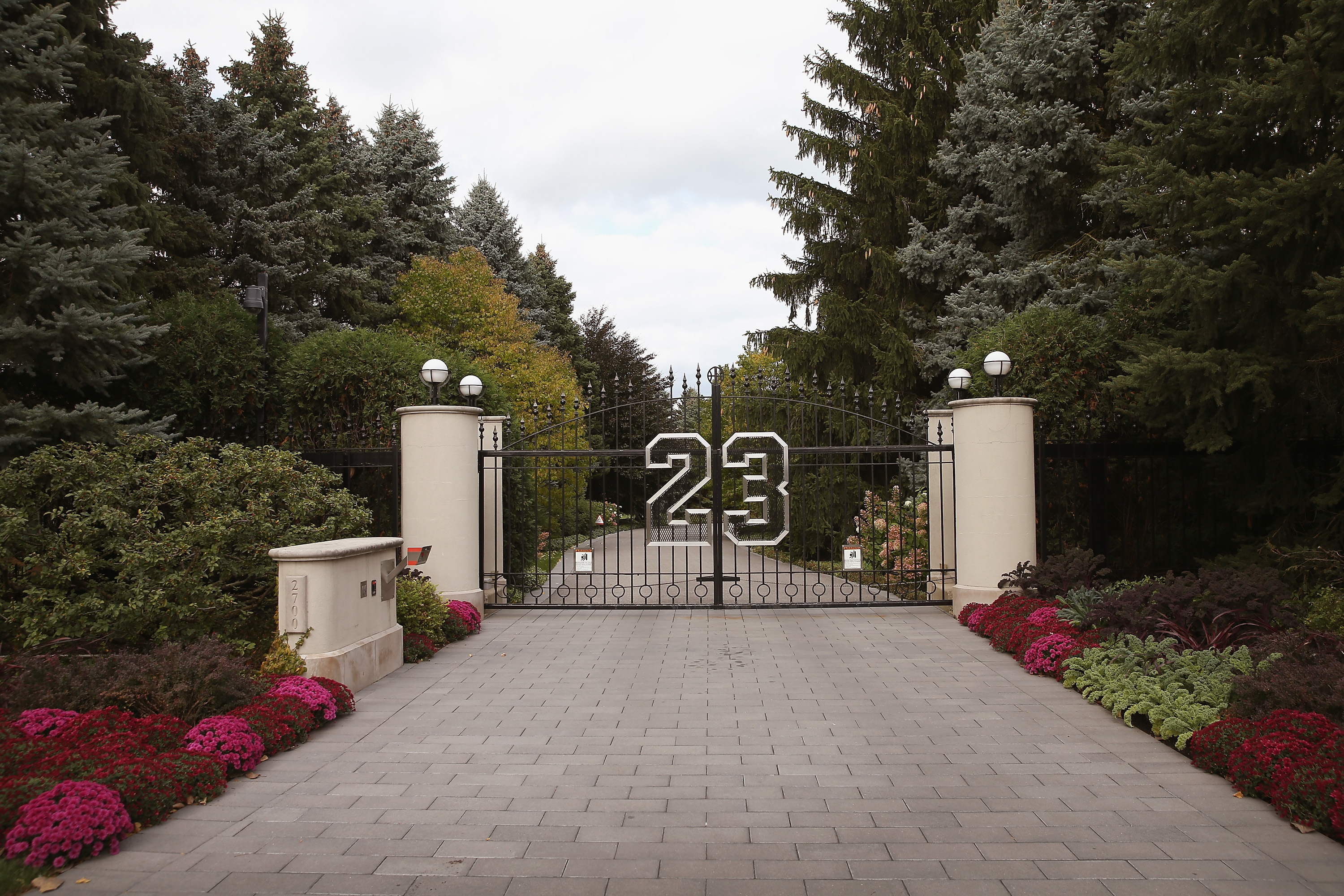 HIGHLAND PARK, IL – OCTOBER 21:  A gate with the number 23 controls access to the home of basketball legend Michael Jordan on October 21, 2013 in Highland Park, Illinois. Twenty-three is the number Jordan wore while playing basketball for the Chicago Bulls. The home which had been offered for sale for $29 million and later dropped to $21 million is scheduled to be sold at auction on November 22. The 32,683-squre-foot home features nine bedrooms, 19 bathrooms, a 15-car attached garage and an “NBA-quality” basketball court.   (Photo by Scott Olson/Getty Images)